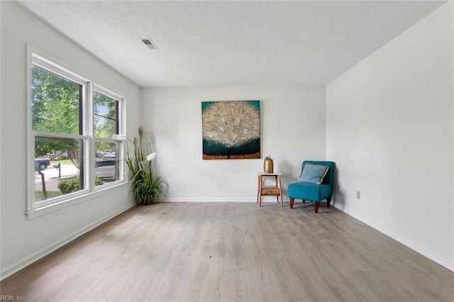 sitting room with light wood finished floors and baseboards