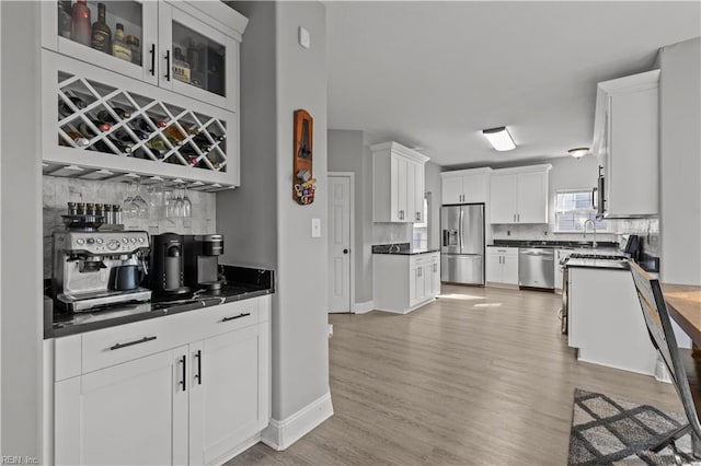 6738 Burbage Landing Cir, Suffolk, VA 23435 - kitchen featuring appliances with stainless steel finishes, backsplash, white cabinets, and dark countertops