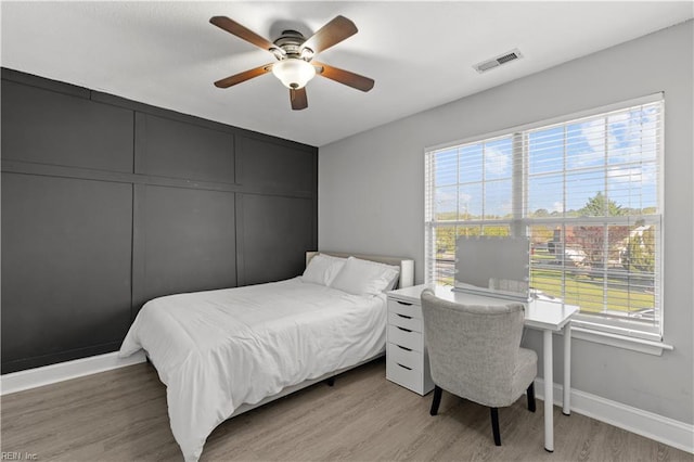 6738 Burbage Landing Cir, Suffolk, VA 23435 - bedroom with baseboards, light wood-style flooring, and a ceiling fan