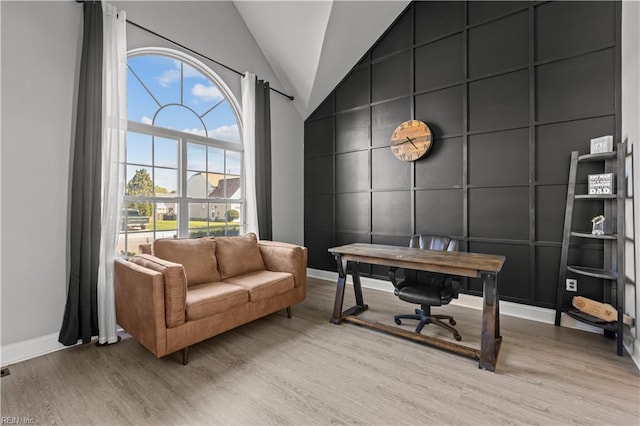 6738 Burbage Landing Cir, Suffolk, VA 23435 - home office with a decorative wall, light wood finished floors, baseboards, lofted ceiling, and an accent wall