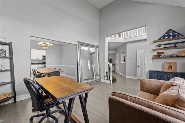6738 Burbage Landing Cir, Suffolk, VA 23435 - office area featuring high vaulted ceiling, a chandelier, wood finished floors, and baseboards