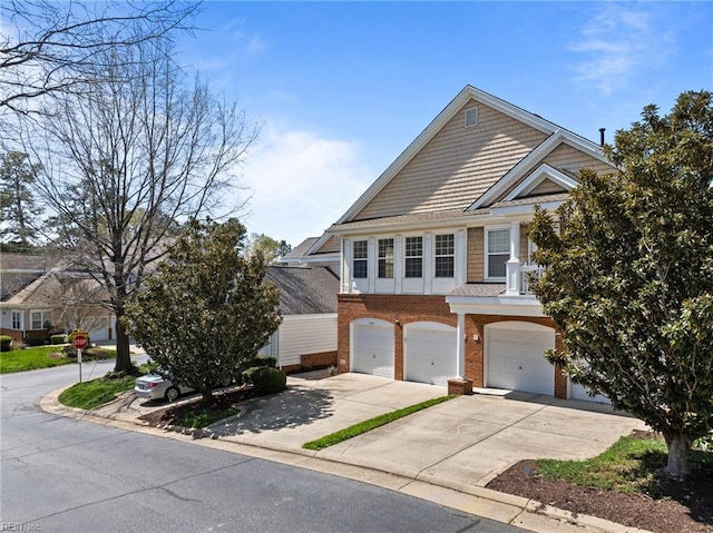 view of front of property with concrete driveway, an attached garage, and brick siding