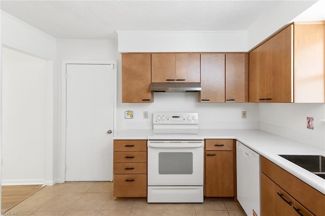 13024 Green Grove Ln, Newport News, VA 23608 - kitchen featuring white appliances, under cabinet range hood, light countertops, light tile patterned floors, and brown cabinets