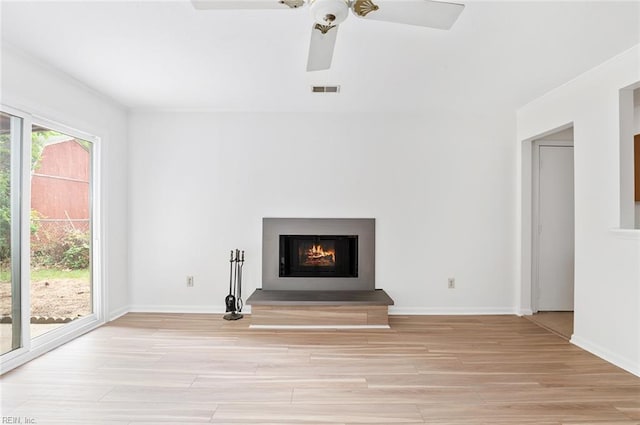 13024 Green Grove Ln, Newport News, VA 23608 - unfurnished living room featuring a ceiling fan, light wood finished floors, a lit fireplace, and baseboards