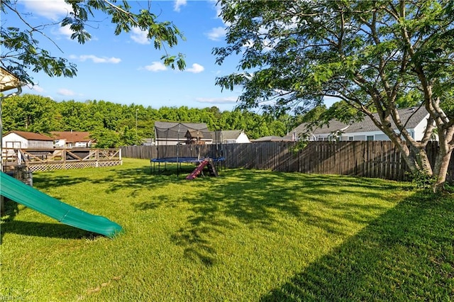 3412 Winterhawk Ct, Chesapeake, VA 23323 - view of yard featuring a trampoline and a wooden deck