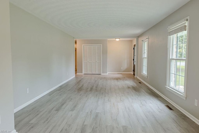 100 Woodland Cir, Franklin, VA 23851 - spare room with wood finished floors, plenty of natural light, and baseboards