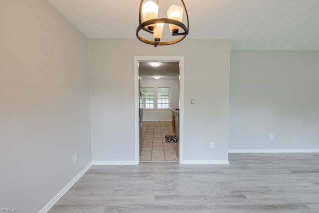 100 Woodland Cir, Franklin, VA 23851 - unfurnished room with a chandelier, light wood-style flooring, and baseboards