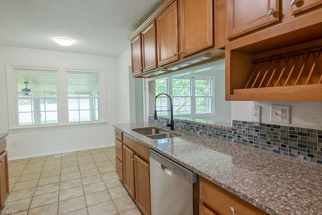 100 Woodland Cir, Franklin, VA 23851 - kitchen featuring stainless steel dishwasher, a sink, brown cabinetry, and plenty of natural light