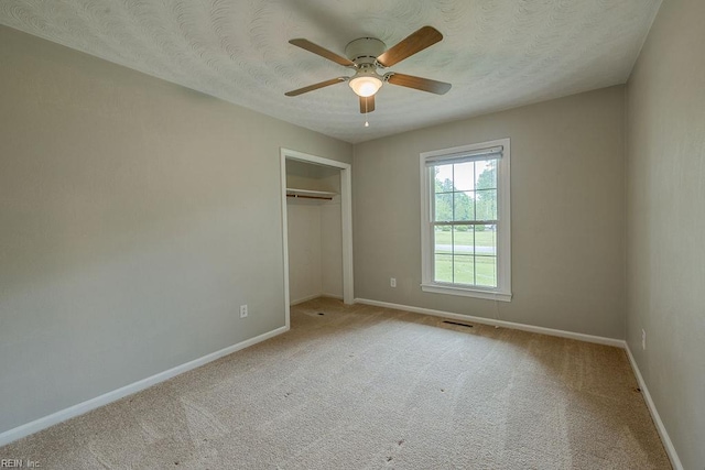 100 Woodland Cir, Franklin, VA 23851 - unfurnished bedroom with baseboards, carpet floors, a closet, ceiling fan, and a textured ceiling