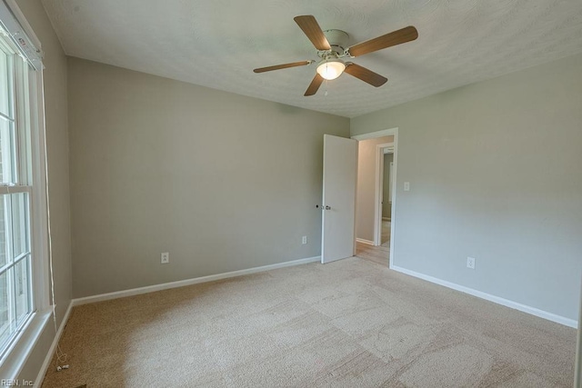 100 Woodland Cir, Franklin, VA 23851 - spare room featuring ceiling fan, light colored carpet, and baseboards