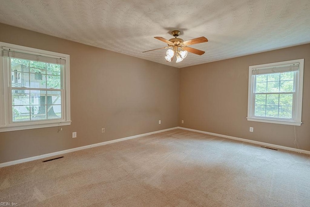 100 Woodland Cir, Franklin, VA 23851 - unfurnished room with healthy amount of natural light, baseboards, ceiling fan, and light colored carpet