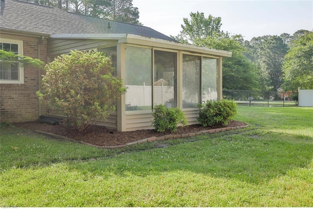 100 Woodland Cir, Franklin, VA 23851 - view of home's exterior with a sunroom, brick siding, and roof with shingles