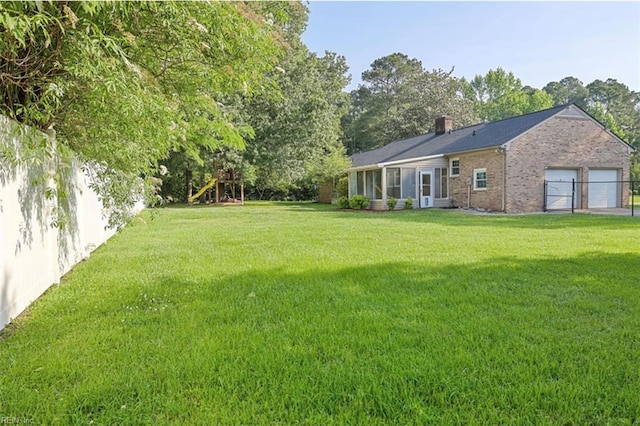 100 Woodland Cir, Franklin, VA 23851 - view of grassy yard with a garage