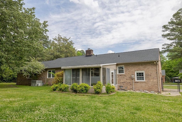 100 Woodland Cir, Franklin, VA 23851 - rear view of house featuring brick siding, a sunroom, a chimney, and central AC