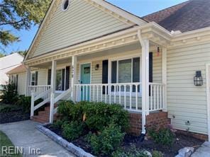 view of front of house featuring covered porch and a shingled roof