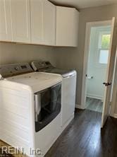 laundry room with washer and dryer, dark wood-style floors, and cabinet space