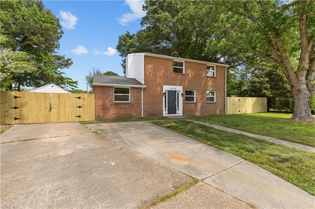 view of front facade featuring a gate and brick siding