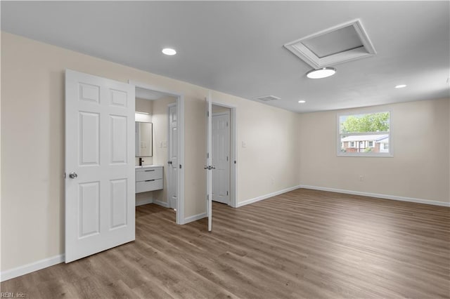 basement featuring wood finished floors, baseboards, and recessed lighting