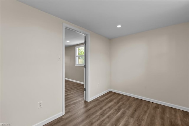 spare room featuring wood finished floors, baseboards, and recessed lighting