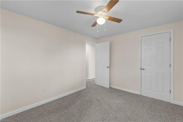 unfurnished bedroom with baseboards, carpet flooring, and ceiling fan