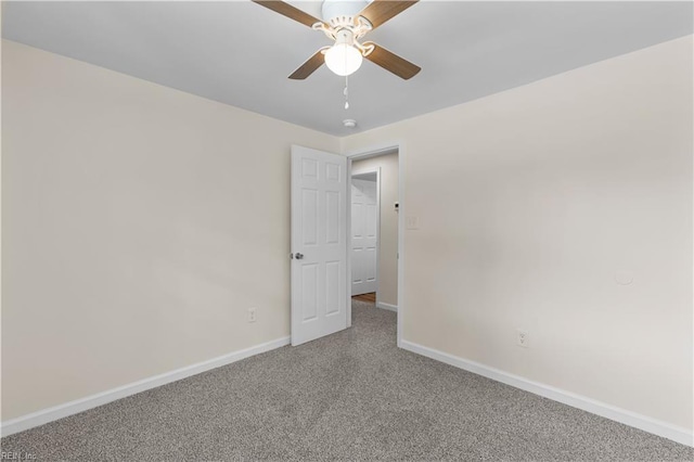unfurnished room with baseboards, ceiling fan, and carpet