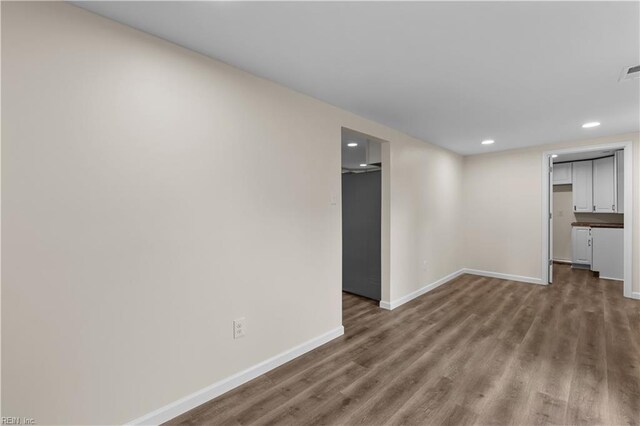 finished basement with baseboards, wood finished floors, and recessed lighting