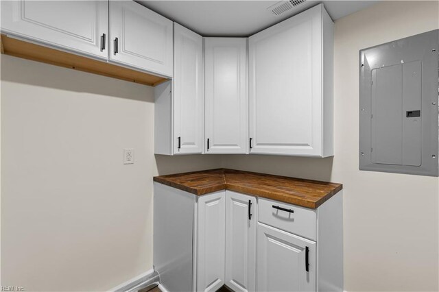 bar featuring electric panel and baseboards