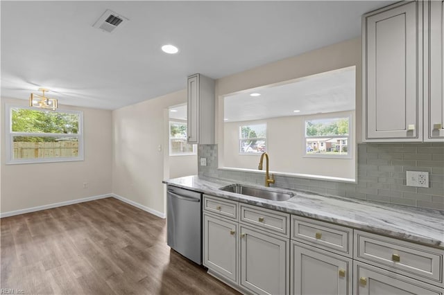 kitchen featuring dishwasher, a sink, decorative backsplash, baseboards, and dark wood-type flooring
