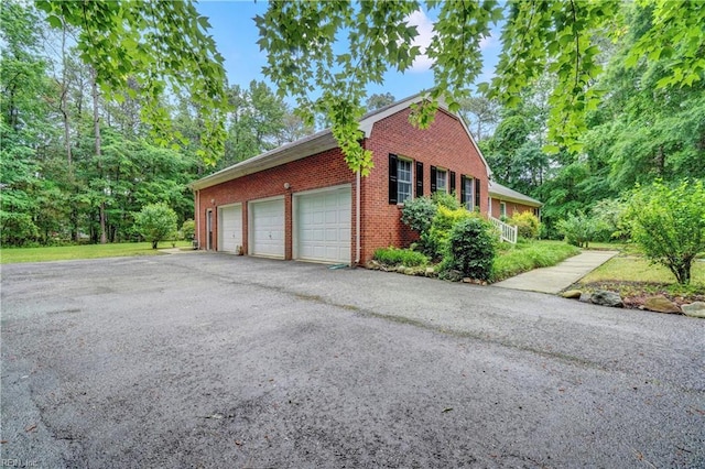 8 Pinckney Ln, Poquoson, VA 23662 - view of home's exterior with brick siding and asphalt driveway