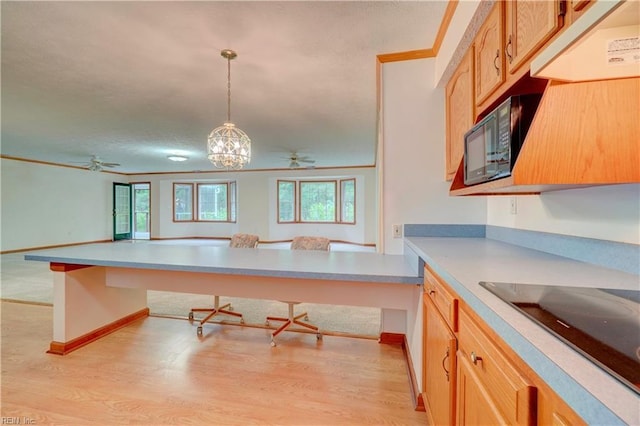 8 Pinckney Ln, Poquoson, VA 23662 - kitchen featuring black appliances, a ceiling fan, a kitchen breakfast bar, light wood-style floors, and light countertops