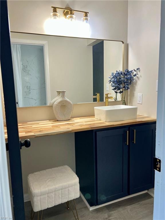 bathroom featuring vanity and wood finished floors