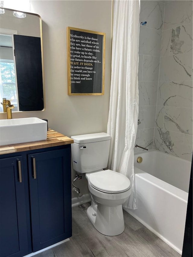 full bathroom featuring vanity, shower / bath combo, wood finished floors, and toilet