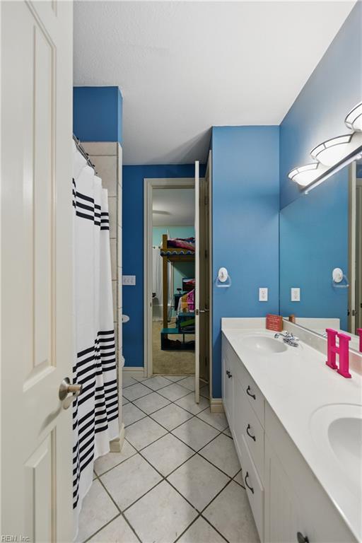200 Avonlea Dr, Chesapeake, VA 23322 - bathroom featuring double vanity, tile patterned floors, and baseboards
