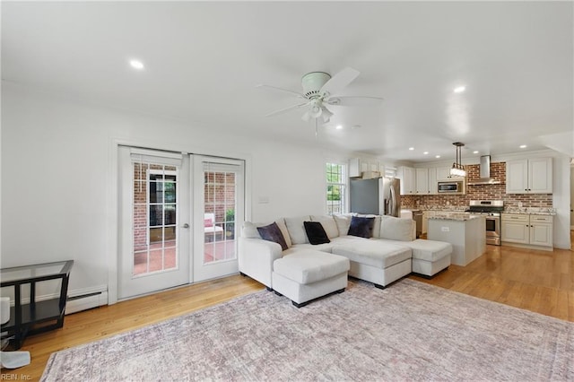 living area with light wood-type flooring, french doors, a ceiling fan, and recessed lighting