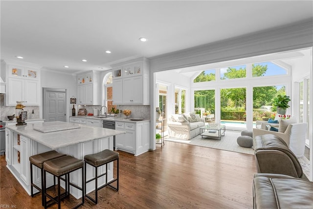 2900 Thomas Smith Ln, Williamsburg, VA 23185 - kitchen featuring open floor plan, white cabinets, ornamental molding, a kitchen breakfast bar, and glass insert cabinets
