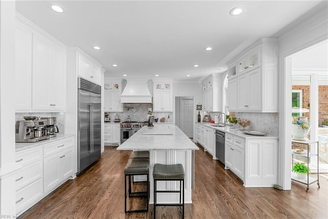 2900 Thomas Smith Ln, Williamsburg, VA 23185 - kitchen with high end appliances, custom exhaust hood, white cabinets, decorative backsplash, and recessed lighting