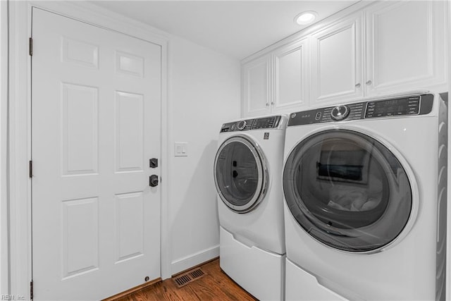 2900 Thomas Smith Ln, Williamsburg, VA 23185 - laundry room featuring washing machine and clothes dryer, cabinet space, dark wood finished floors, and recessed lighting