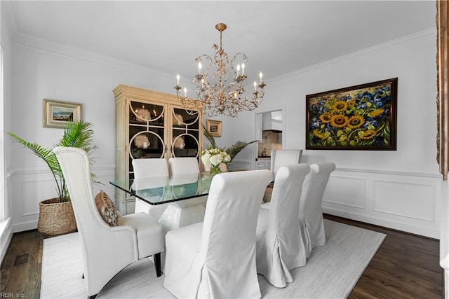 2900 Thomas Smith Ln, Williamsburg, VA 23185 - dining space with a chandelier, wood finished floors, a decorative wall, ornamental molding, and a wainscoted wall