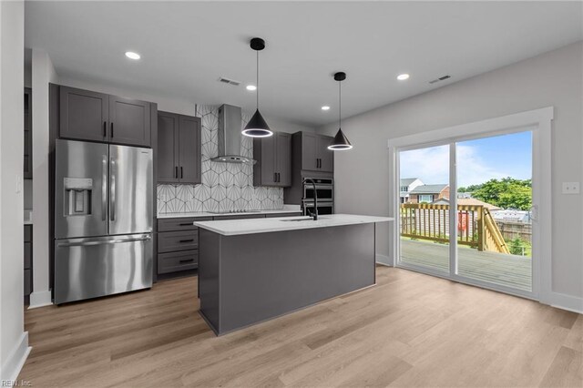 433 Cooper St, Hampton, VA 23669 - kitchen featuring stainless steel appliances, wall chimney range hood, light countertops, light wood-type flooring, and recessed lighting