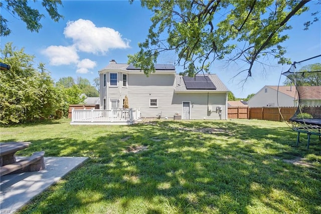 2809 Cedar Cove Ln, Chesapeake, VA 23323 - back of property featuring a trampoline, solar panels, a deck, and a chimney
