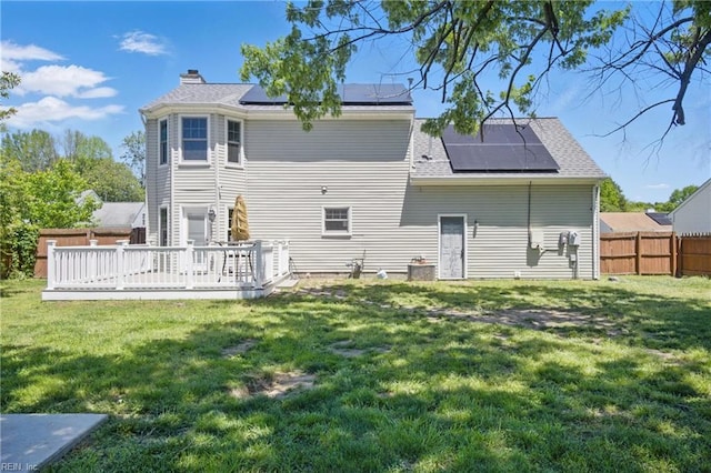 2809 Cedar Cove Ln, Chesapeake, VA 23323 - back of property with solar panels, a chimney, and a wooden deck
