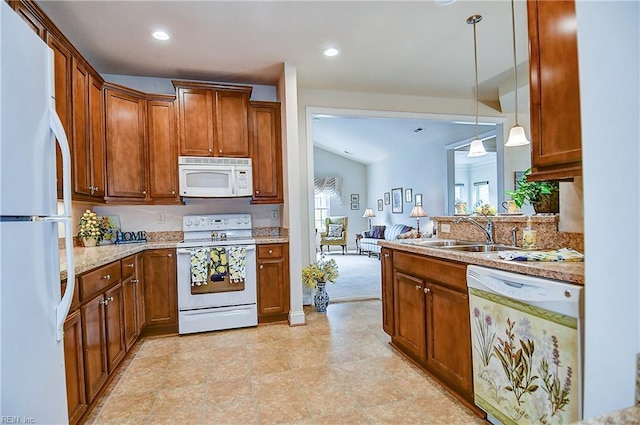 kitchen featuring white appliances, brown cabinets, pendant lighting, recessed lighting, and a sink