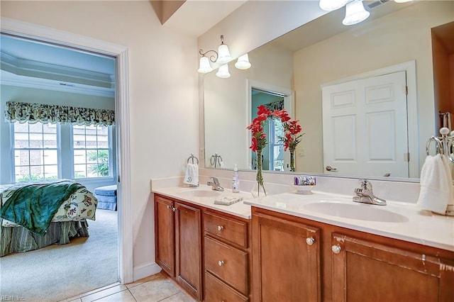 ensuite bathroom featuring double vanity, tile patterned flooring, and a chandelier