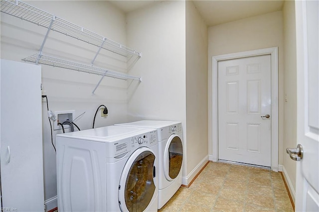 laundry room featuring separate washer and dryer and baseboards