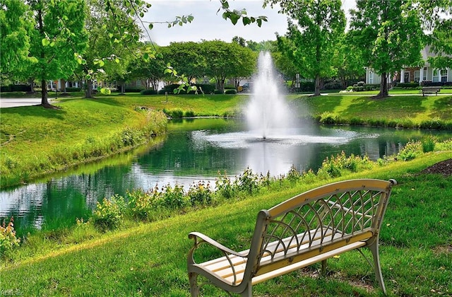 view of property's community featuring a water view and a yard
