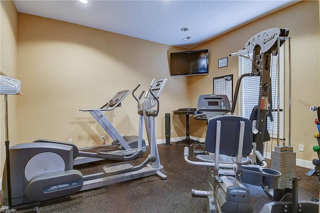 exercise area featuring baseboards and recessed lighting