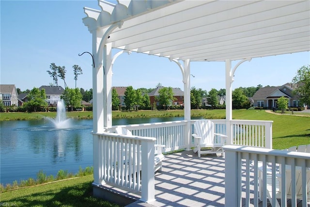 wooden terrace featuring a water view, a pergola, a lawn, and a residential view