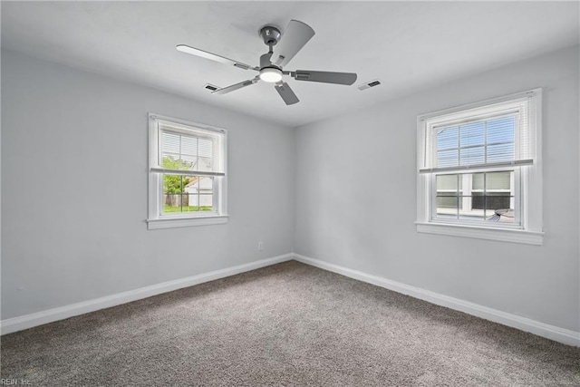 empty room featuring carpet, baseboards, and a ceiling fan