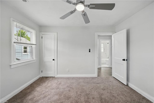 unfurnished bedroom featuring carpet, baseboards, and a ceiling fan