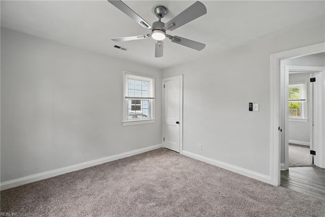 unfurnished room with carpet flooring, plenty of natural light, baseboards, and a ceiling fan